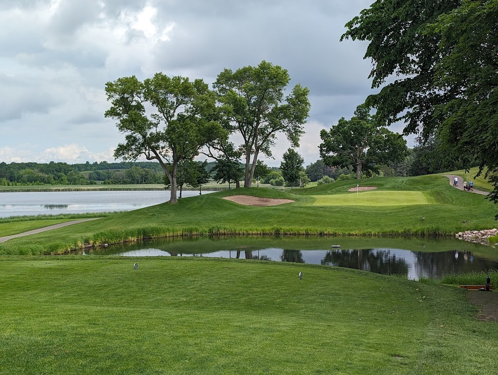 Panoramic view of a lush green golf course at Baker National Golf Course. Smooth