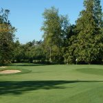 Panoramic view of a lush green golf course at Bald Eagle Golf Course. Smooth