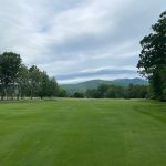 Panoramic view of a lush green golf course at Bald Peak Colony Club. Smooth