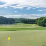 Panoramic view of a lush green golf course at Ballantrae Golf Club. Smooth