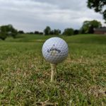 green grass with the flag in the hole.