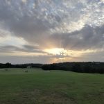 Panoramic view of a lush green golf course at Barton Creek Fazio Canyons Golf Course. Smooth