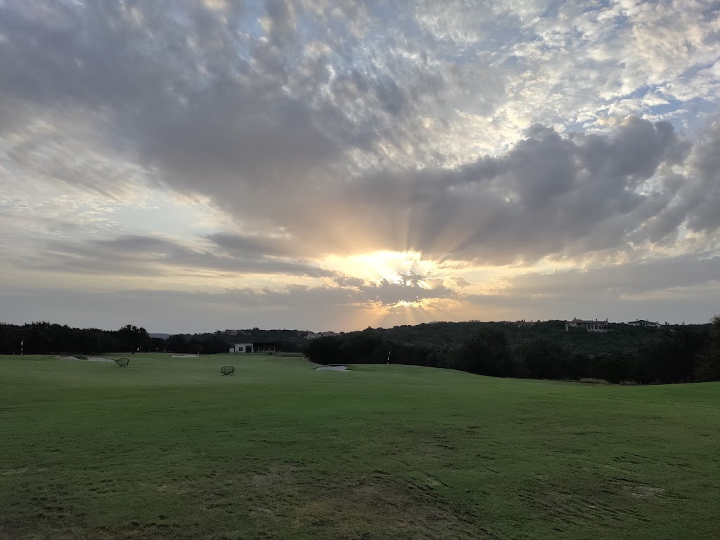 Panoramic view of a lush green golf course at Barton Creek Fazio Canyons Golf Course. Smooth