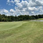 Panoramic view of a lush green golf course at Bartram Trail Golf Club. Smooth