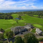 Panoramic view of a lush green golf course at Bass Rocks Golf Club. Smooth