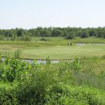 Panoramic view of a lush green golf course at Battle Creek Golf Club. Smooth