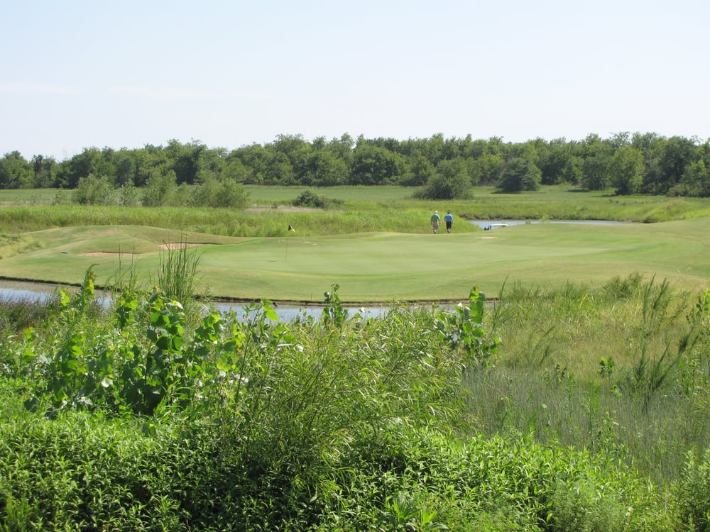 Panoramic view of a lush green golf course at Battle Creek Golf Club. Smooth