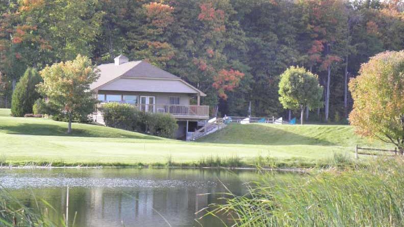 Panoramic view of a lush green golf course at Bay Meadows Family Golf Course. Smooth