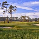 Panoramic view of a lush green golf course at Bayside Resort Golf Club. Smooth