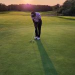 green grass with the flag in the hole.