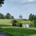 Panoramic view of a lush green golf course at Baywood Greens. Smooth