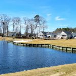 Panoramic view of a lush green golf course at Baywood Greens Golf Course and Clubhouse. Smooth