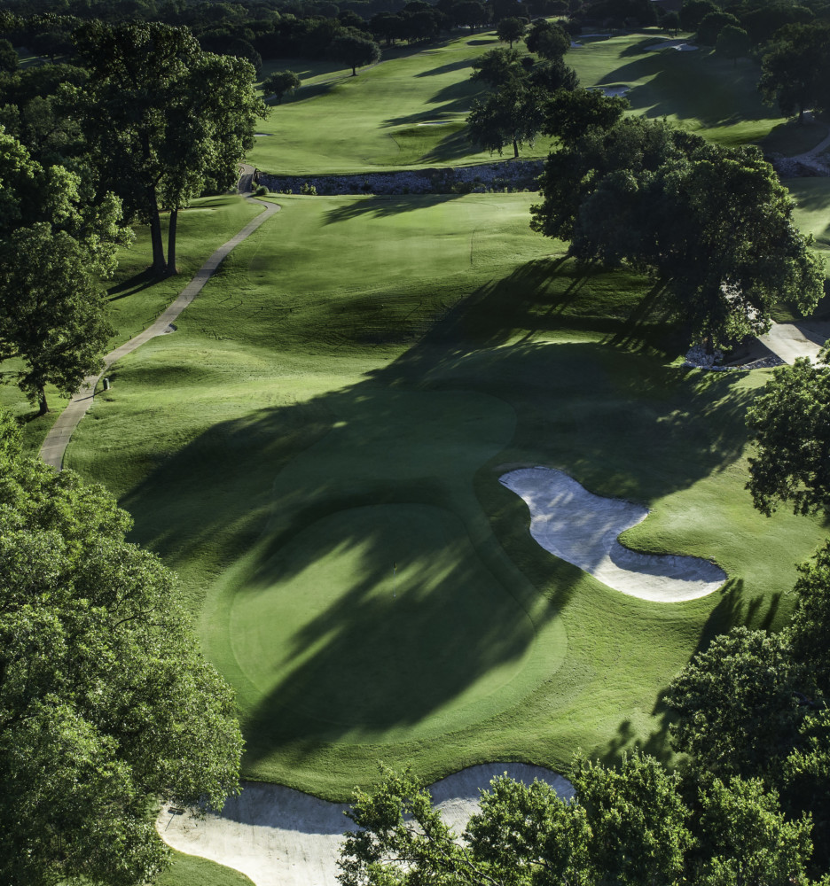 Panoramic view of a lush green golf course at Bear Creek Golf Club. Smooth
