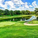 Panoramic view of a lush green golf course at Bear Creek Valley Golf Club. Smooth