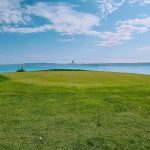 Panoramic view of a lush green golf course at Bear Lake West Golf Course. Smooth