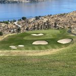 Panoramic view of a lush green golf course at Bear Mountain Ranch. Smooth