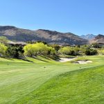 Panoramic view of a lush green golf course at Bear's Best Las Vegas. Smooth