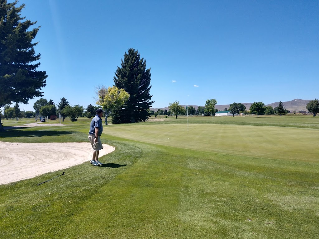 Panoramic view of a lush green golf course at Beaverhead Golf Club. Smooth