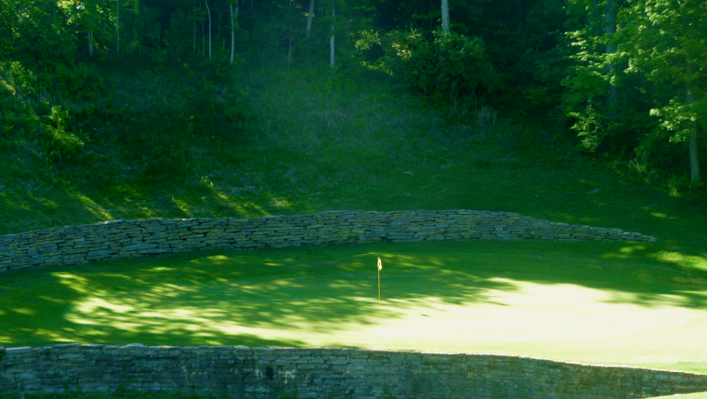 Panoramic view of a lush green golf course at Beech Creek Golf Course. Smooth