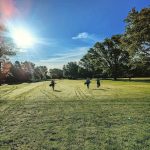 Panoramic view of a lush green golf course at Bel-Aire Golf Course. Smooth