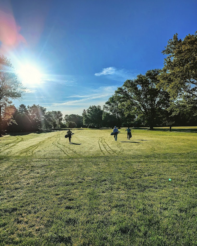 Panoramic view of a lush green golf course at Bel-Aire Golf Course. Smooth