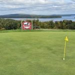 green grass with the flag in the hole.