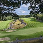 Panoramic view of a lush green golf course at Belgrade Lakes Golf Club. Smooth