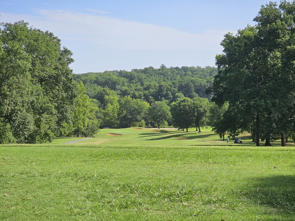 Panoramic view of a lush green golf course at Bella Vista Country Club Golf Course and Clubhouse. Smooth