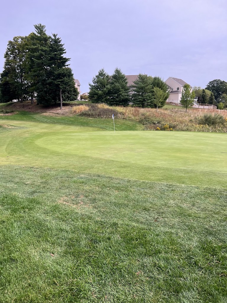 Panoramic view of a lush green golf course at Bella Vista Golf Course. Smooth