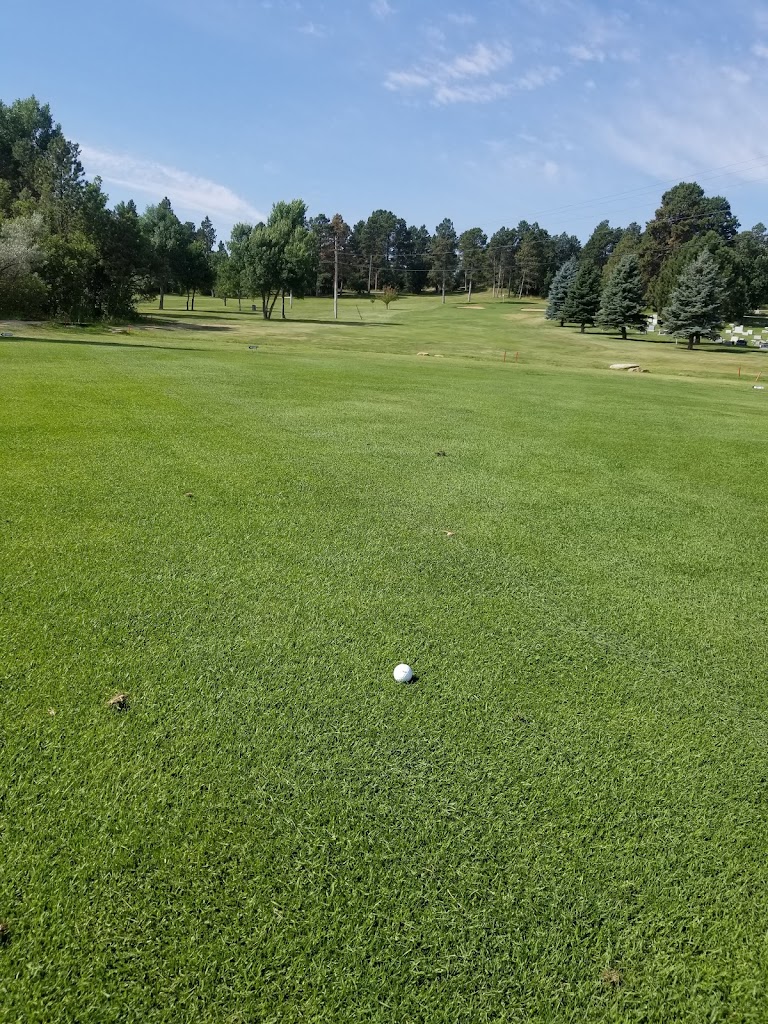 Panoramic view of a lush green golf course at Belle Fourche Country Club. Smooth