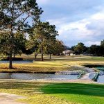 Panoramic view of a lush green golf course at Belle Terre Country Club. Smooth