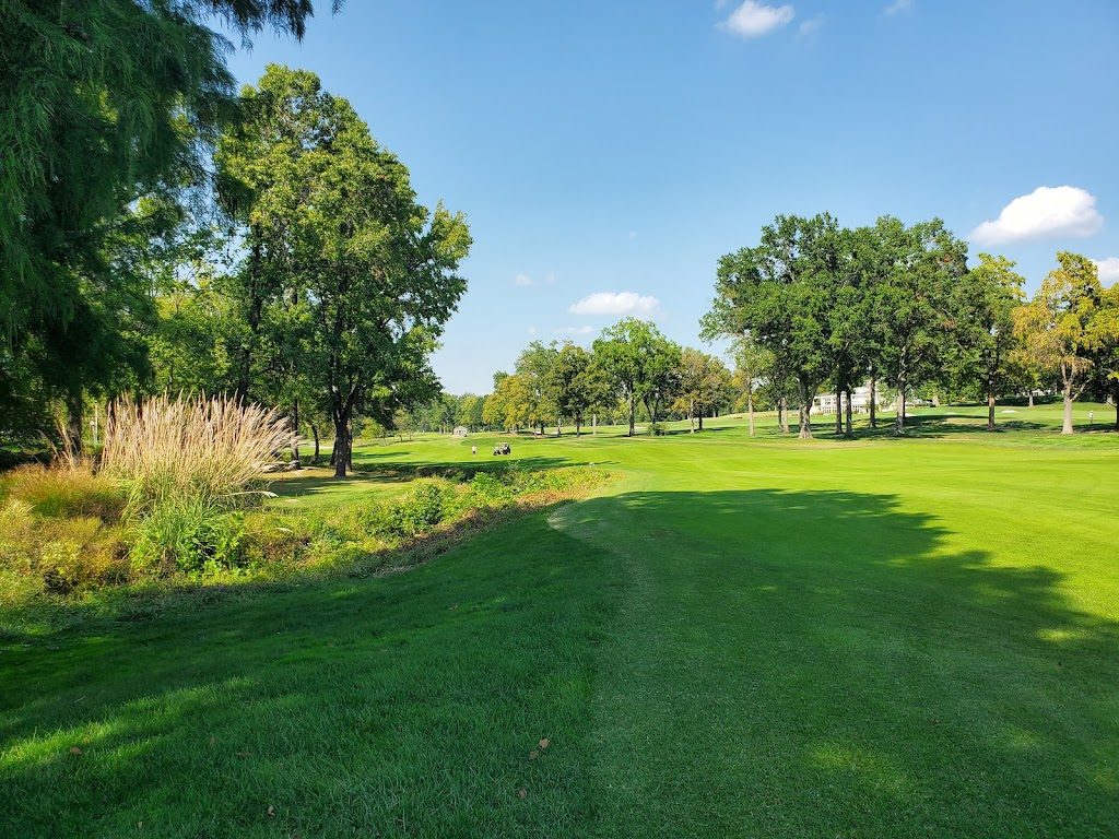 Panoramic view of a lush green golf course at Bellerive Country Club. Smooth