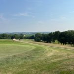 Panoramic view of a lush green golf course at Bellevue Golf Club. Smooth