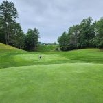 Panoramic view of a lush green golf course at Bellows Falls Country Club. Smooth