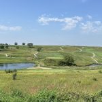 Panoramic view of a lush green golf course at Bent Tree Golf Club. Smooth