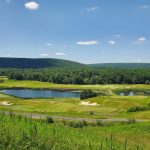 Panoramic view of a lush green golf course at Berkshire Valley Golf Course. Smooth