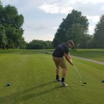 green grass with the flag in the hole.