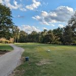 Panoramic view of a lush green golf course at Berry Hill Golf Course. Smooth