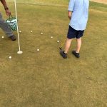 green grass with the flag in the hole.