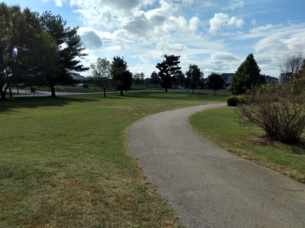 Panoramic view of a lush green golf course at Bill & Payne Stewart Golf Course. Smooth