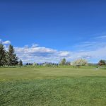 Panoramic view of a lush green golf course at Bill Roberts Golf Course. Smooth