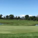 Panoramic view of a lush green golf course at Bird Creek Golf Club. Smooth