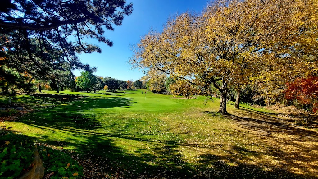 Panoramic view of a lush green golf course at Birnamwood Golf Course. Smooth