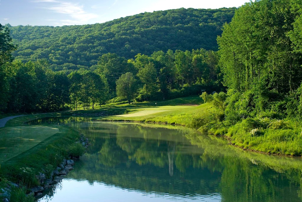 Panoramic view of a lush green golf course at Black Bear Golf Club. Smooth