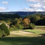 Panoramic view of a lush green golf course at Black Creek Club. Smooth