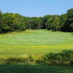 Panoramic view of a lush green golf course at Black Lake Golf Club. Smooth