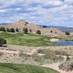Panoramic view of a lush green golf course at Black Mesa Golf Club. Smooth