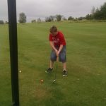 green grass with the flag in the hole.