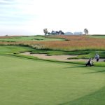 green grass with the flag in the hole.