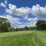 Panoramic view of a lush green golf course at Blackberry Oaks Golf Course. Smooth